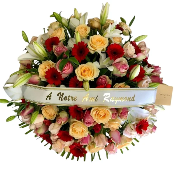 Coussin rond de roses rouges, saumon, roses et gerberas rouges